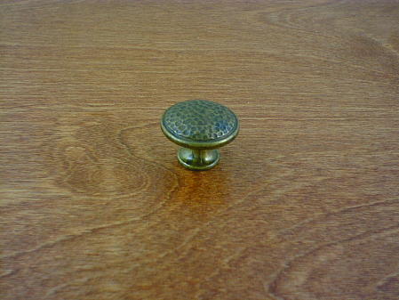 old brass anviled top round button knob