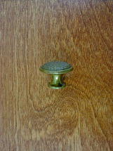 old brass anviled top round button knob